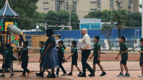 international school of wuxi elementary students walking outside with their teachers