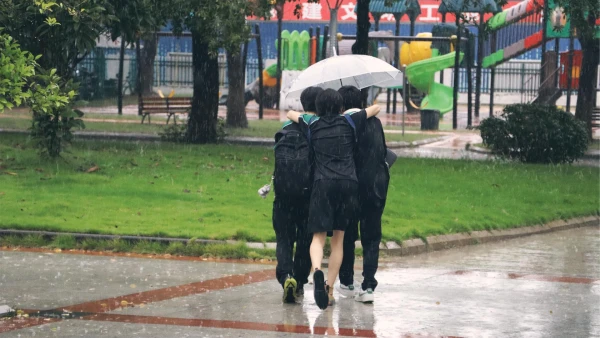 international school of wuxi high school students outside in the rain