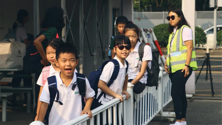 international school of wuxi campus students await their bus
