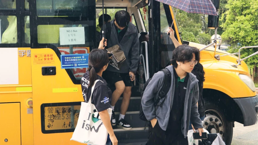 international school of wuxi high school students arriving to campus via bus