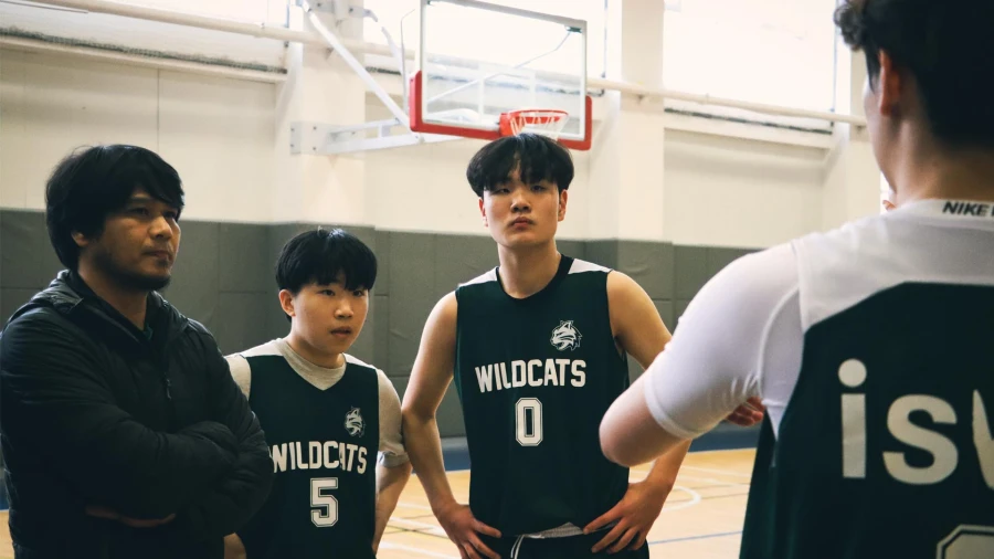 International School of Wuxi High School basketball team learning from their coach