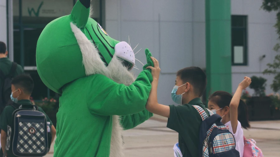 international school of wuxi student and green tiger mascot